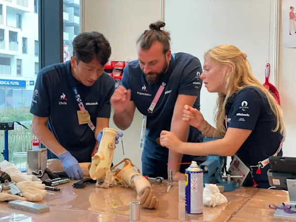 Paris 2024 Technicians repairing an arm prosthesis at the Repair Service Center in the Paralympic Village in Paris.