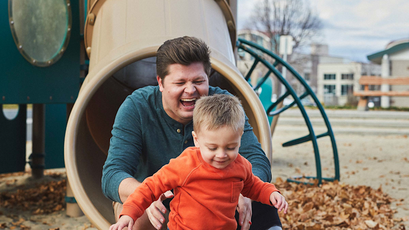 MyFit TT user Dilon Stephens plays with his child on the playground.