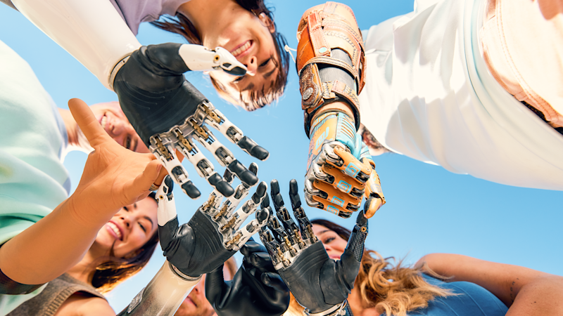 Upper limb protheses user build a circle with their hands.