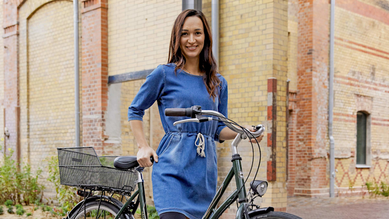 MyFit TT user Danuta stands by her bicycle and is ready to ride.