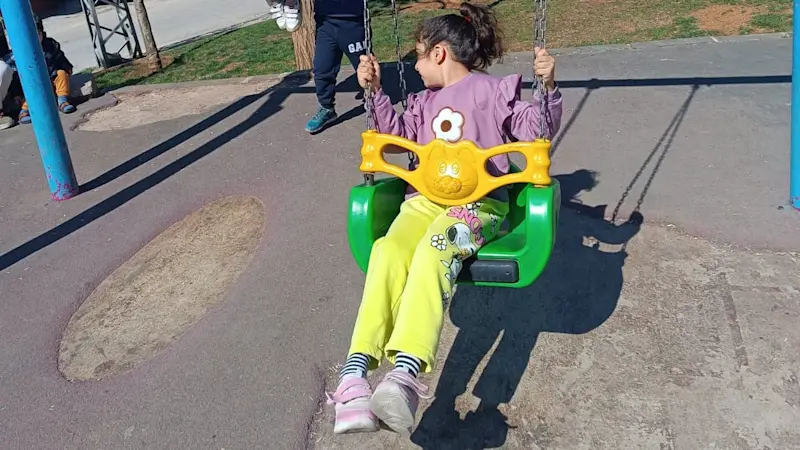 Aysima is having a carefree romp on the playground.