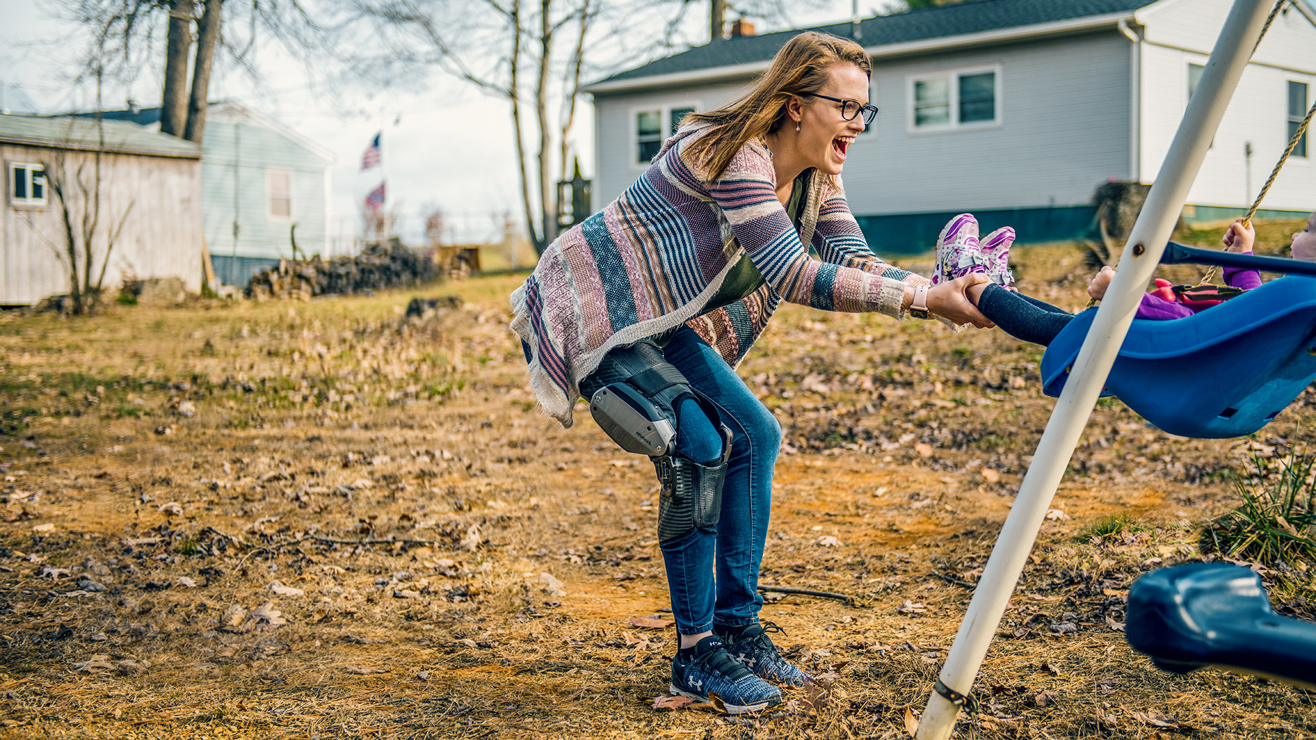 Image C-Brace orthosis user Hannah with her child while swinging