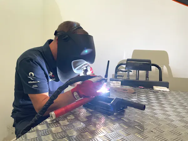 Paris 2024 Welding technician repairing a wheelchair frame at the Repair Service Center in the Paralympic Village in Paris.