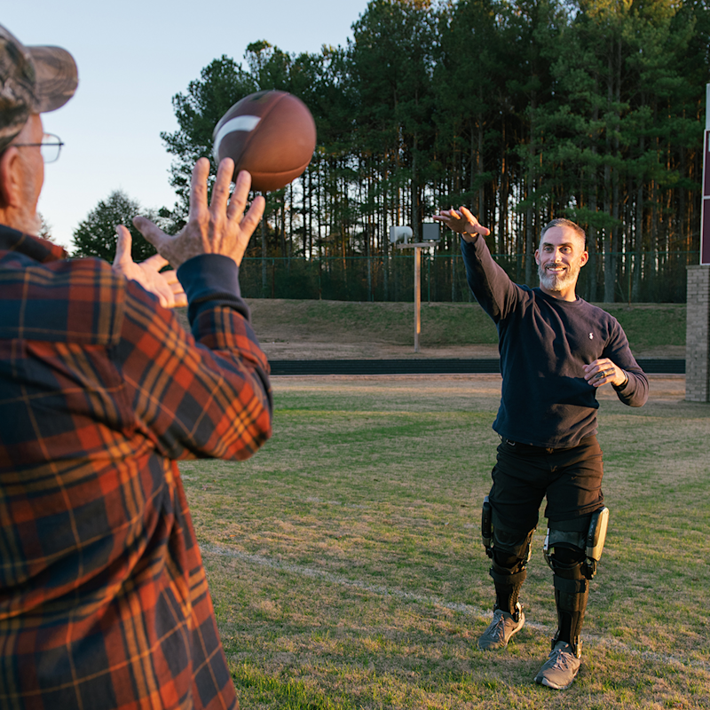 Image C-Brace user David T.  on a Football field with his dad