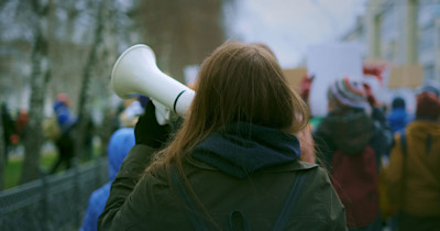 Banner-young-woman-at-demonstration.jpg