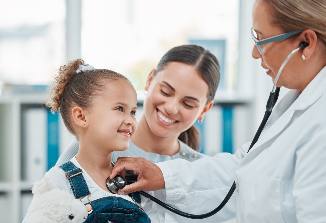 Shot of a doctor examining a little girl with a stethoscope in a clinic stock photo