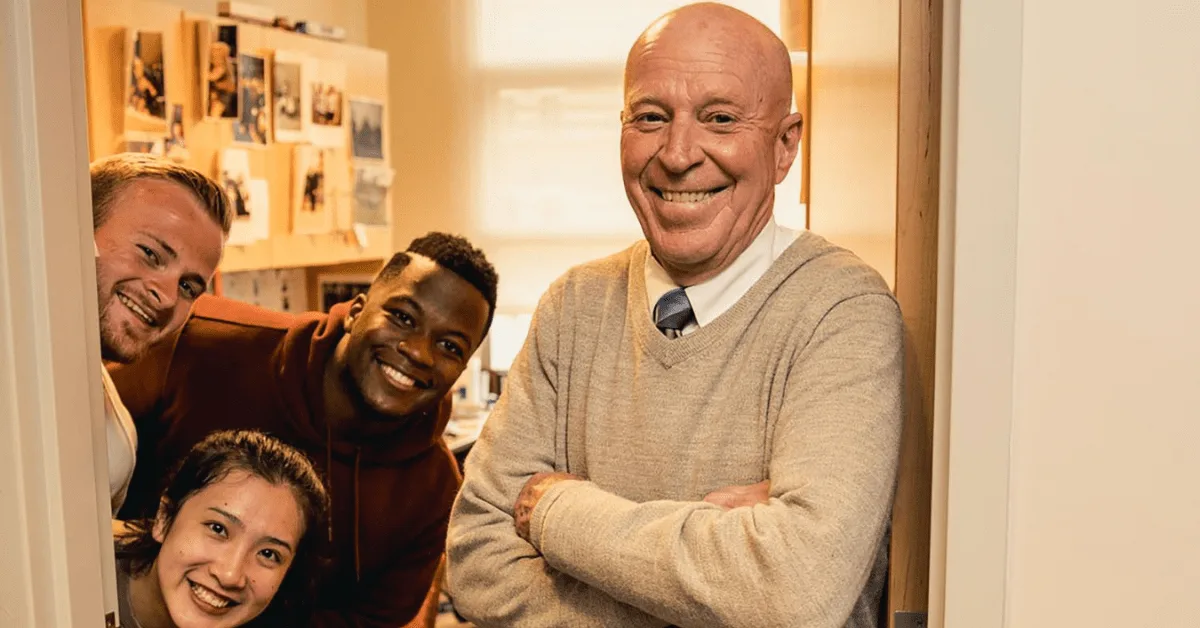Photo of Bob Novack and students in his office
