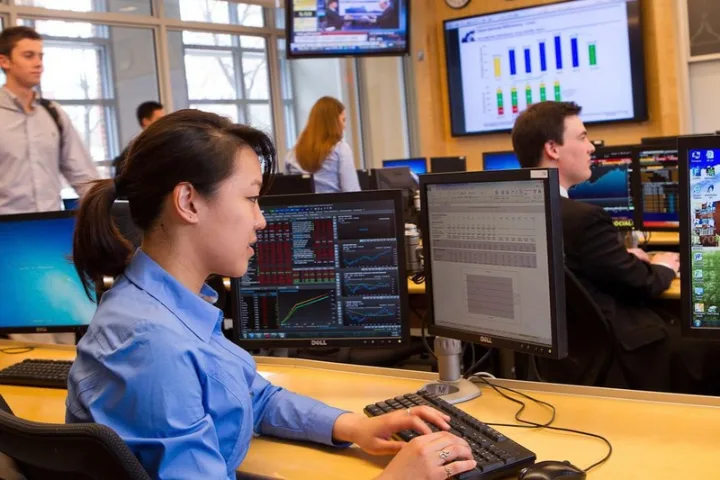 Emily Zheng reviews financial information in the Rogers Family Trading Room