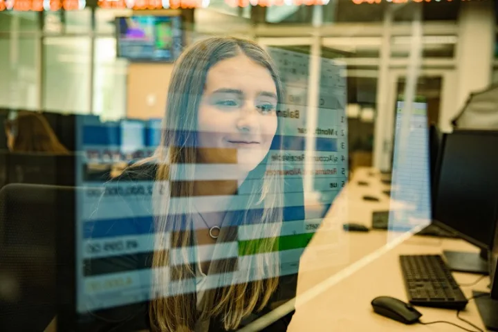 Student with spreadsheet superimposed over their face