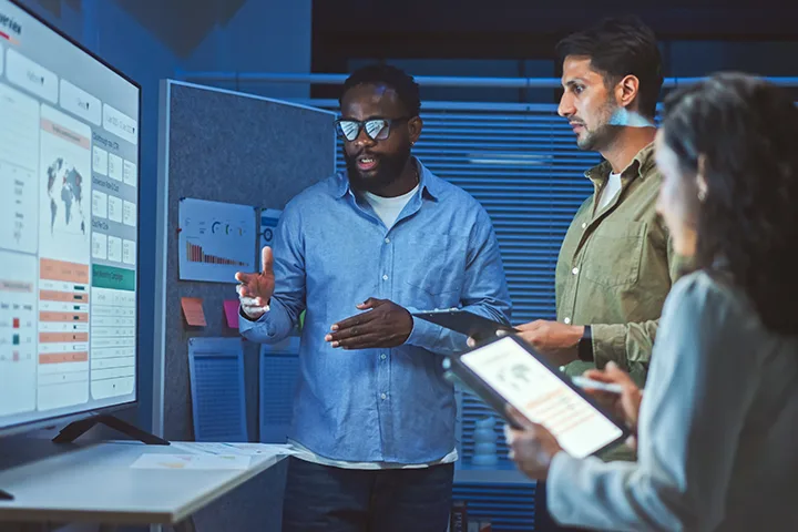 Man at board explaining data