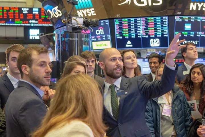 Professor giving students a tour of the stock market