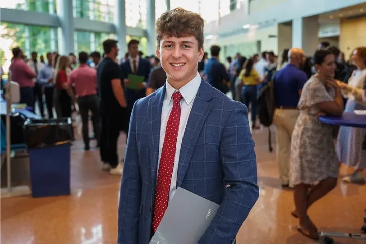 Student in a suit at the Networking Expo