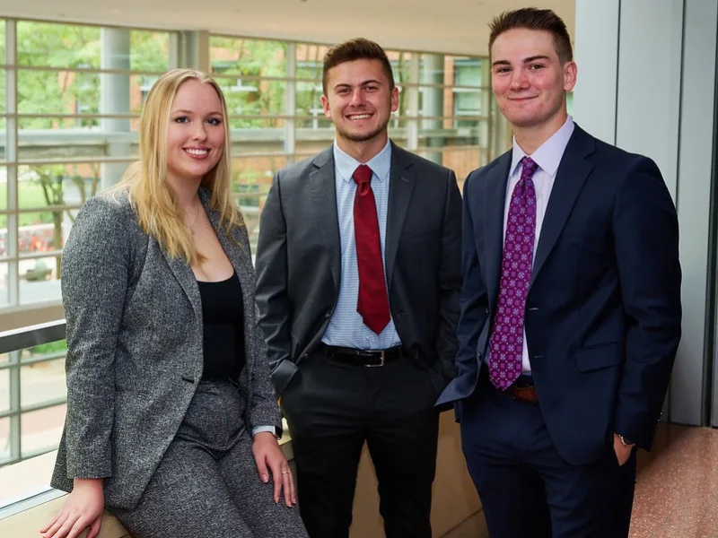 Three students in suits