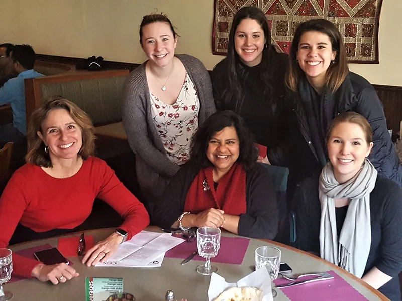 Group of students and faculty at a restaurant
