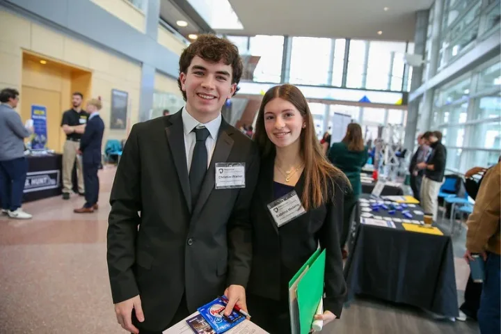 Two students in suits at a career fair