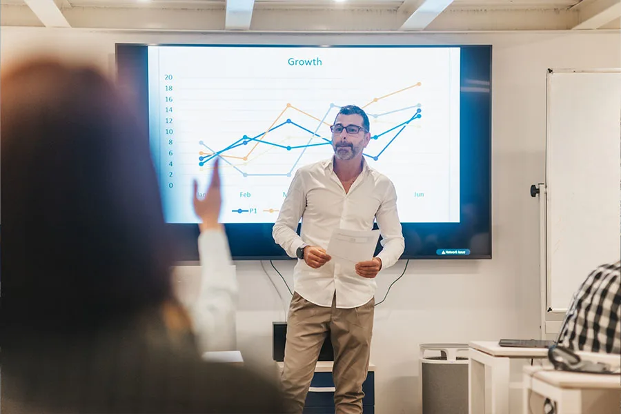 Business trainer listening to a group of employees