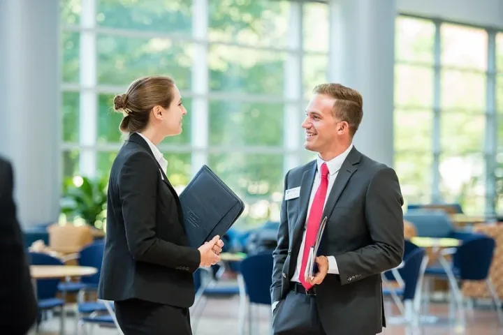 Two people speaking at the networking expo