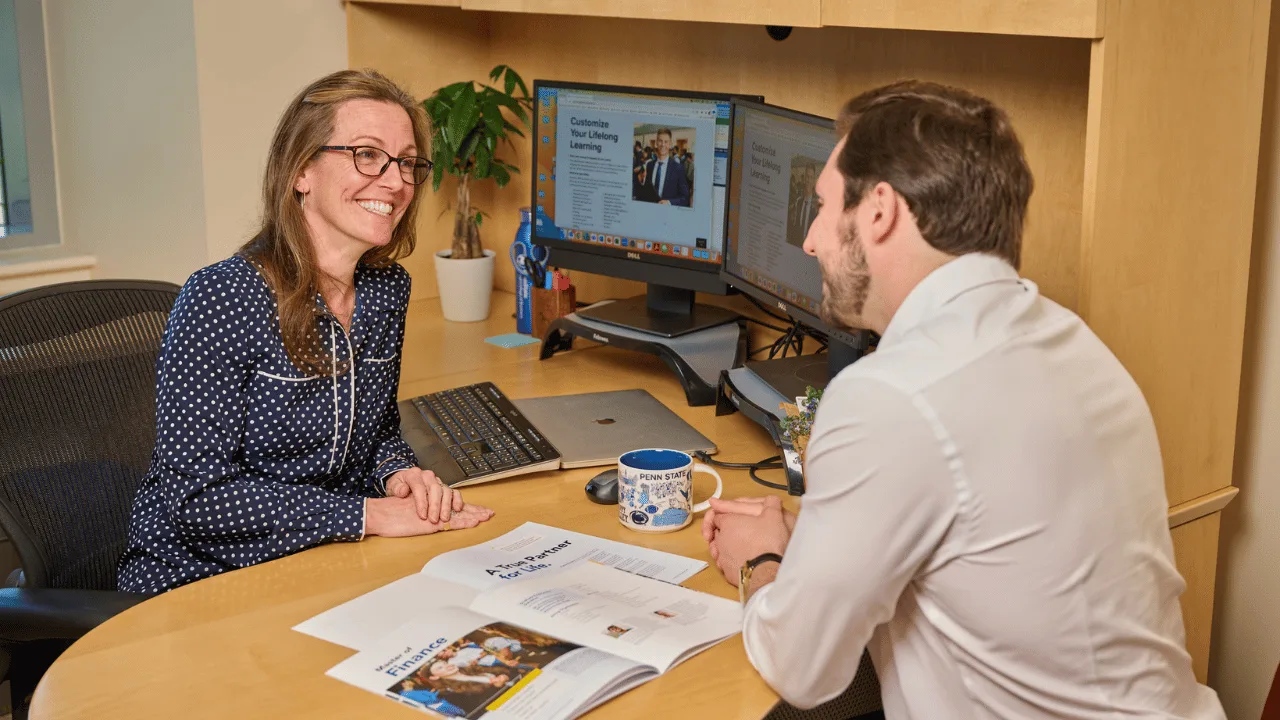Smeal Graduate programs staff Andrea Murphy-Faust speaks with a student in her office.