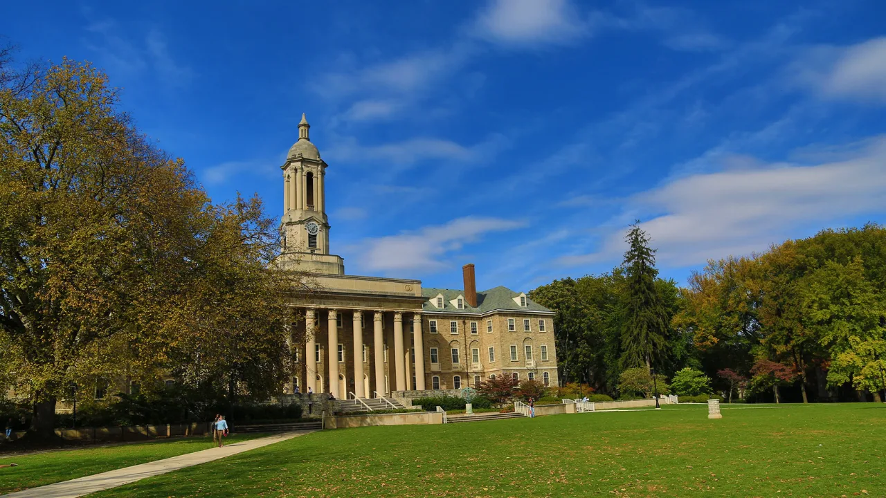 University Park campus building with green lawn and trees