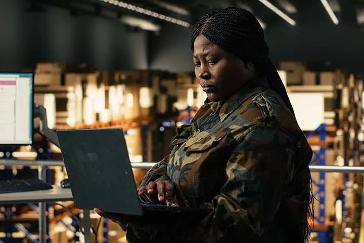 Woman in military uniform managing supply chain data