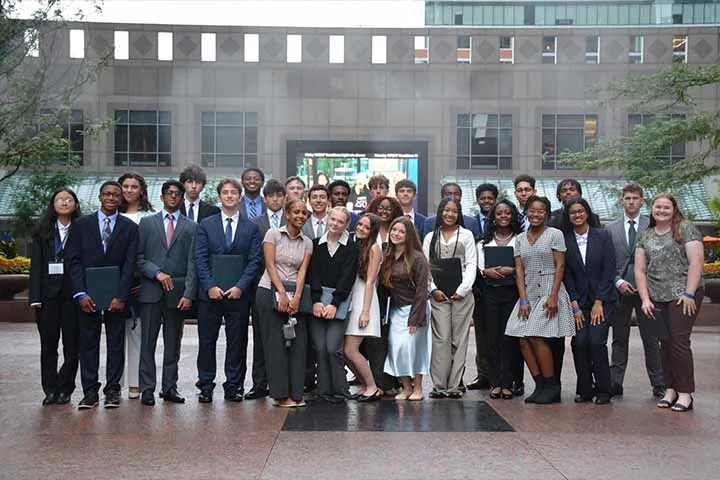 Students standing in front of an office