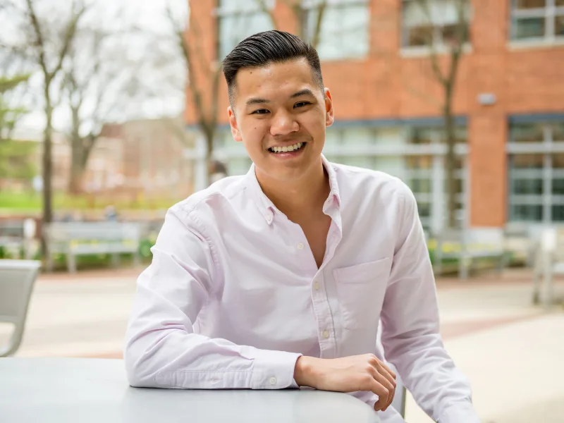 Student smiling at camera in the Business Building atrium