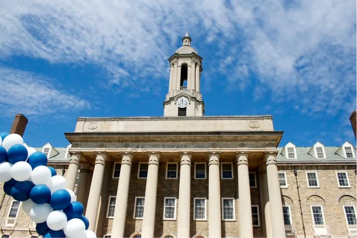 Old Main building with balloon bunches on University Park campus