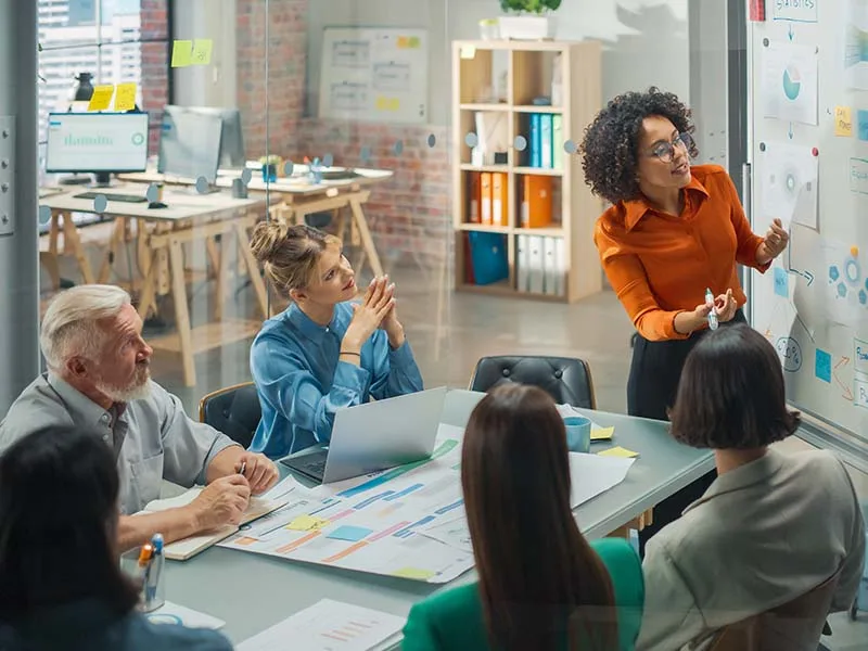 Woman presenting in front of group