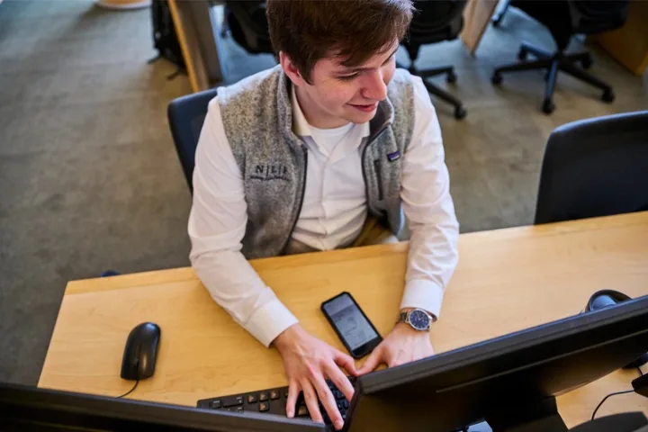 Student working on stocks in Rogers Family Trading Room