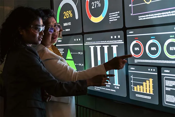 Two women studying analytics dashboard