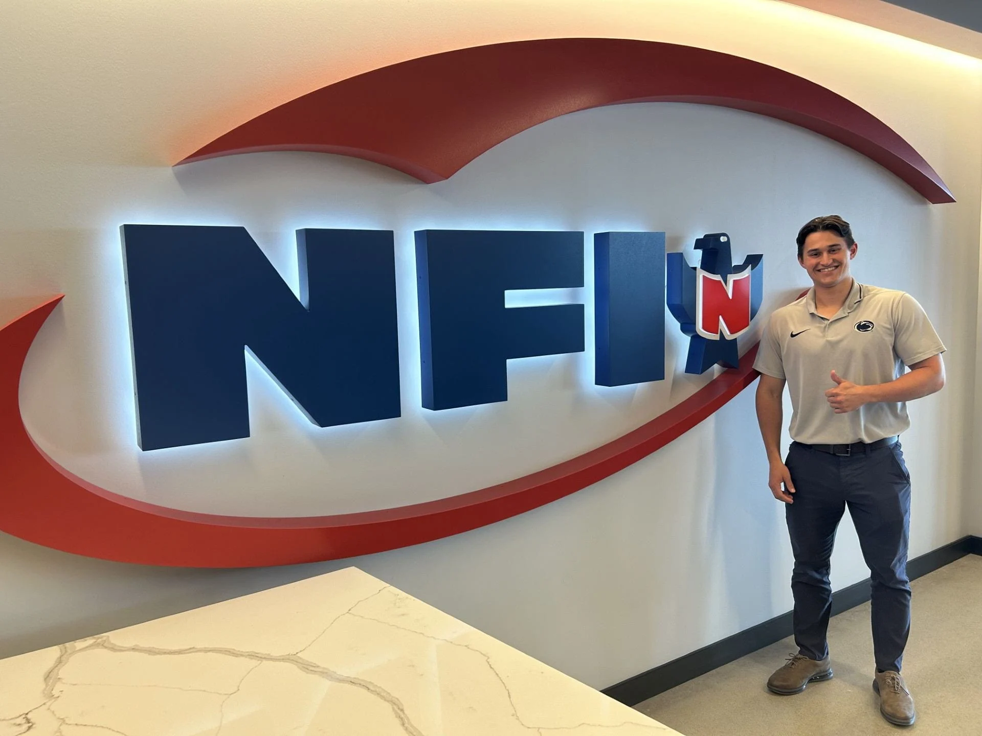 Zach Whyte by the NFI Industries sign.