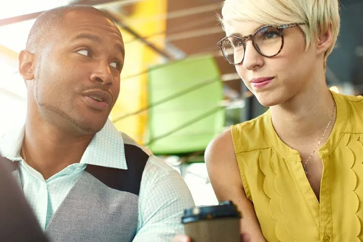 Two people speaking with each other about work.