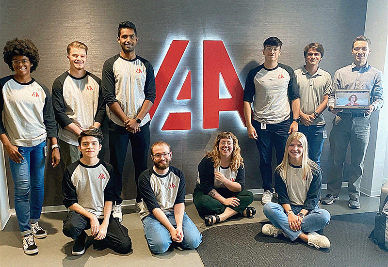 IAA summer interns in front of IAA logo