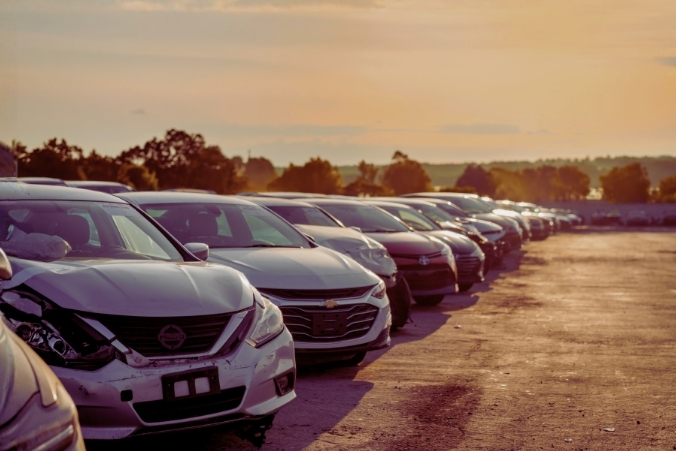 Cars parked in a lot at sunset