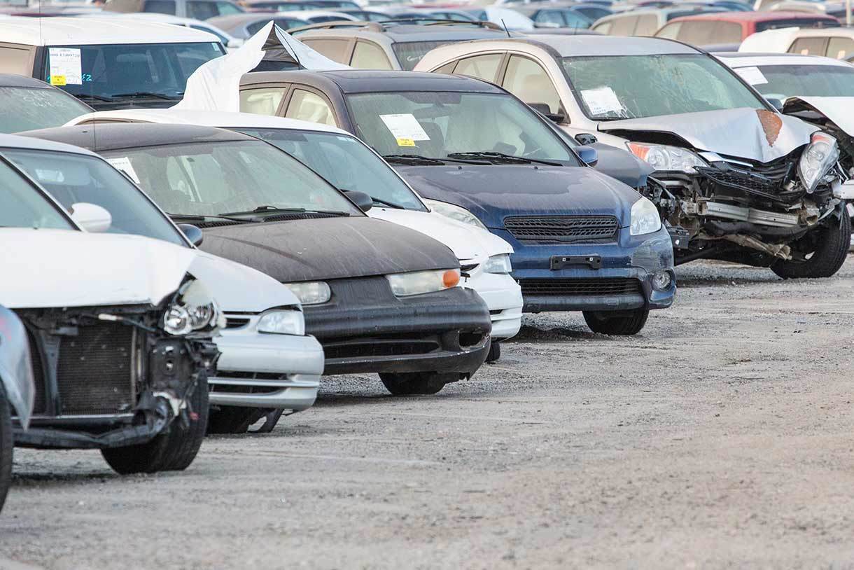 Line of partially damaged cars parked in an IAA branch lot