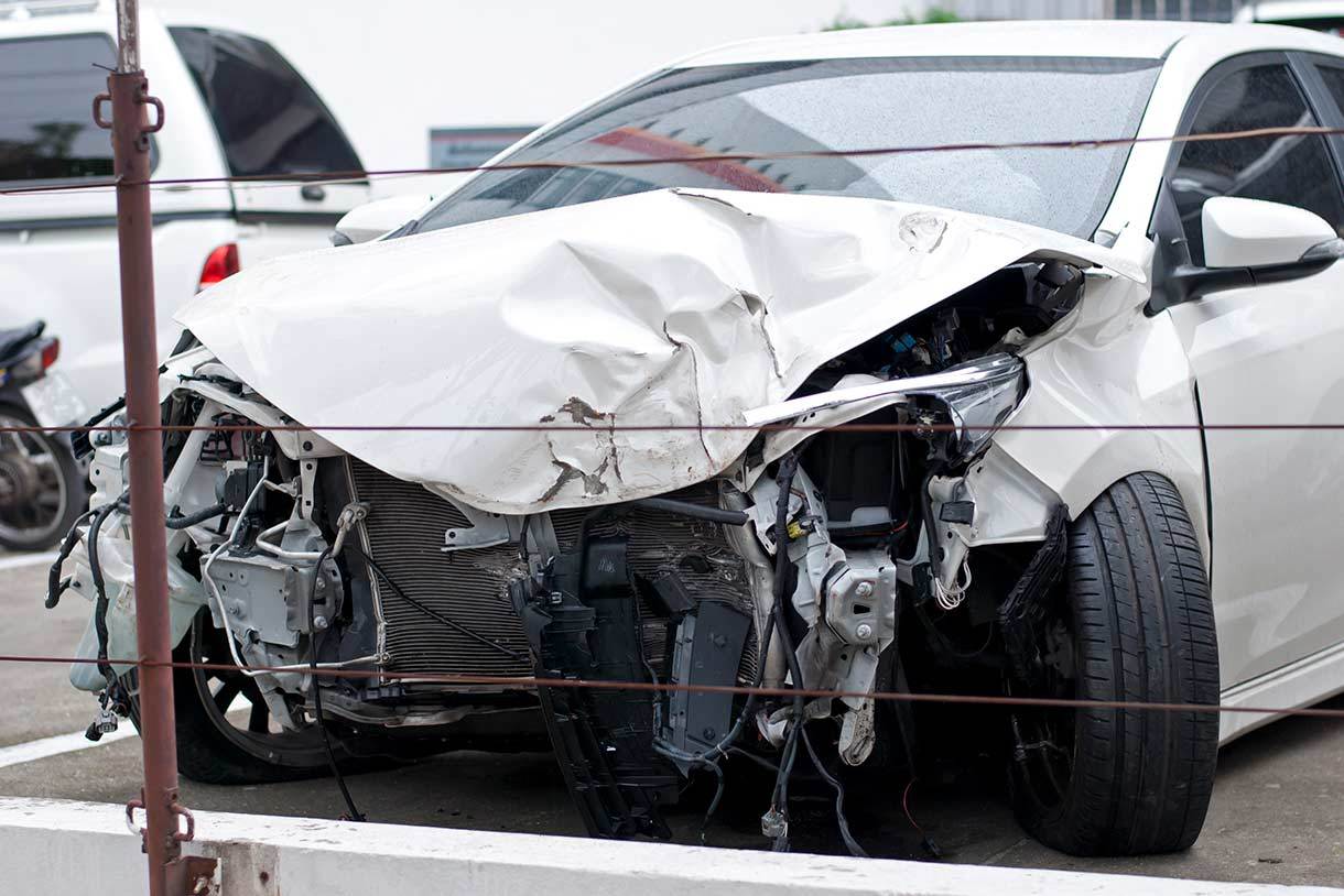 Damaged front of white vehicle