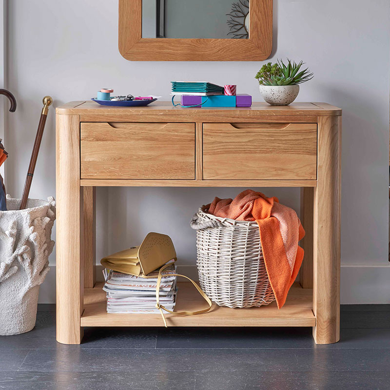 oak console table against grey walls and grey floor