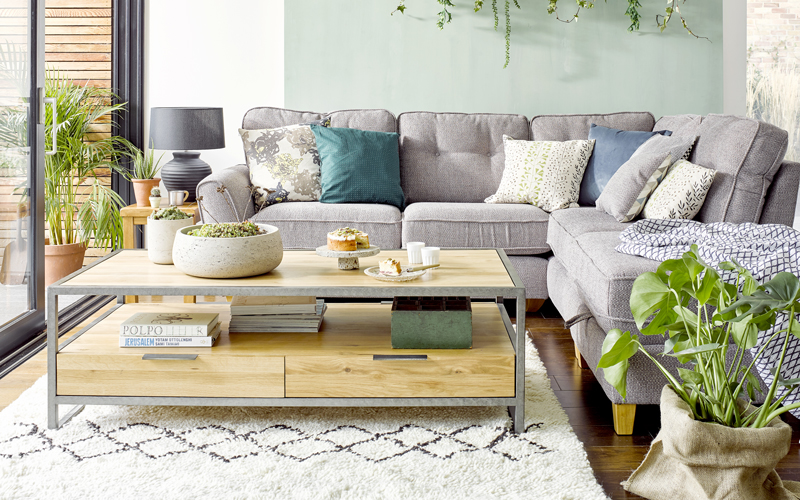 Industrial coffee table and sofa in green botanical living-room