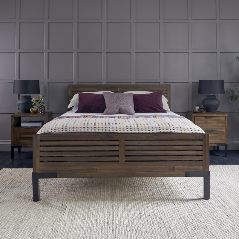 Dark wood King-Size bed and bedside tables against grey panelled walls. 