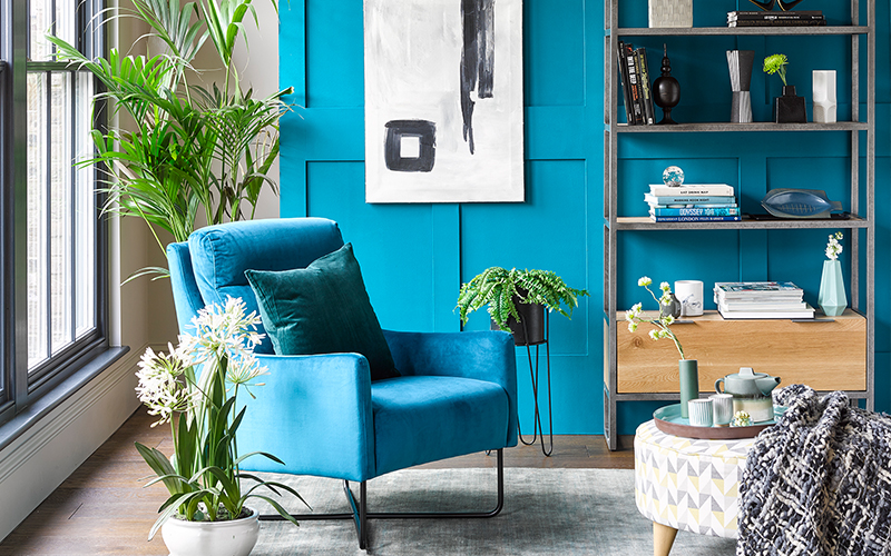 industrial chair and bookcase in blue living room
