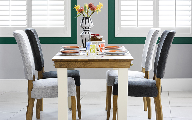 oak and white painted dining table with fabric chairs