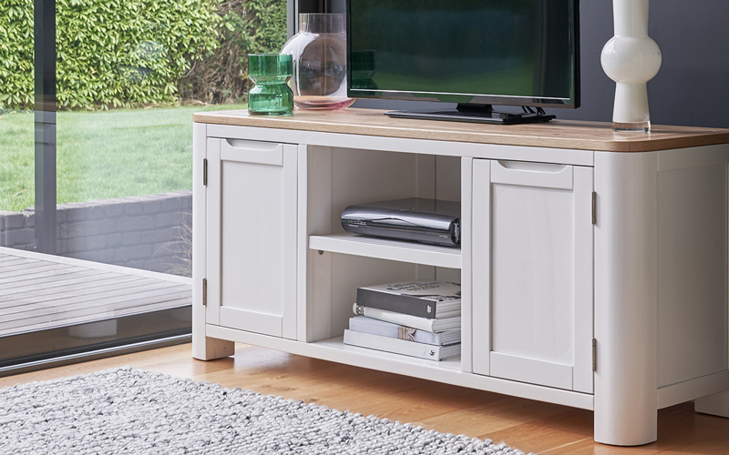 Large white TV unit in blue painted living room