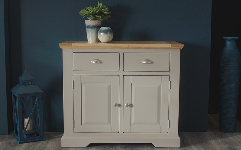 grey small sideboard against blue background