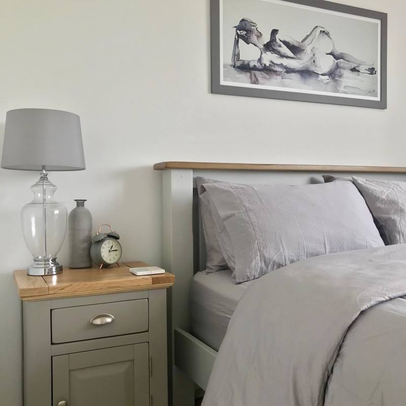 Natural oak and grey painted matching bed and bedside table in neutral bedroom