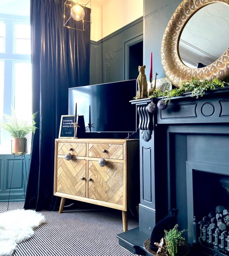 Small mid century modern sideboard used as a TV unit in a Victorian-style living room