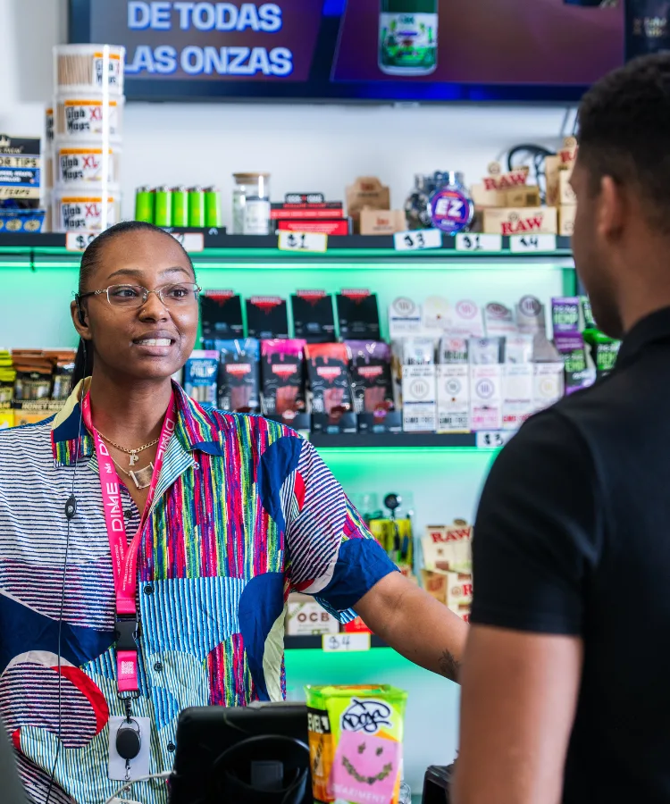 Budtender at Erb and Arbor dispensary talking with a regular customer about loyalty rewards