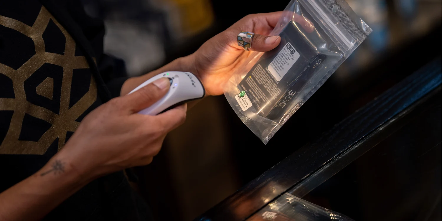 Dispensary staff scanning a cannabis product barcode