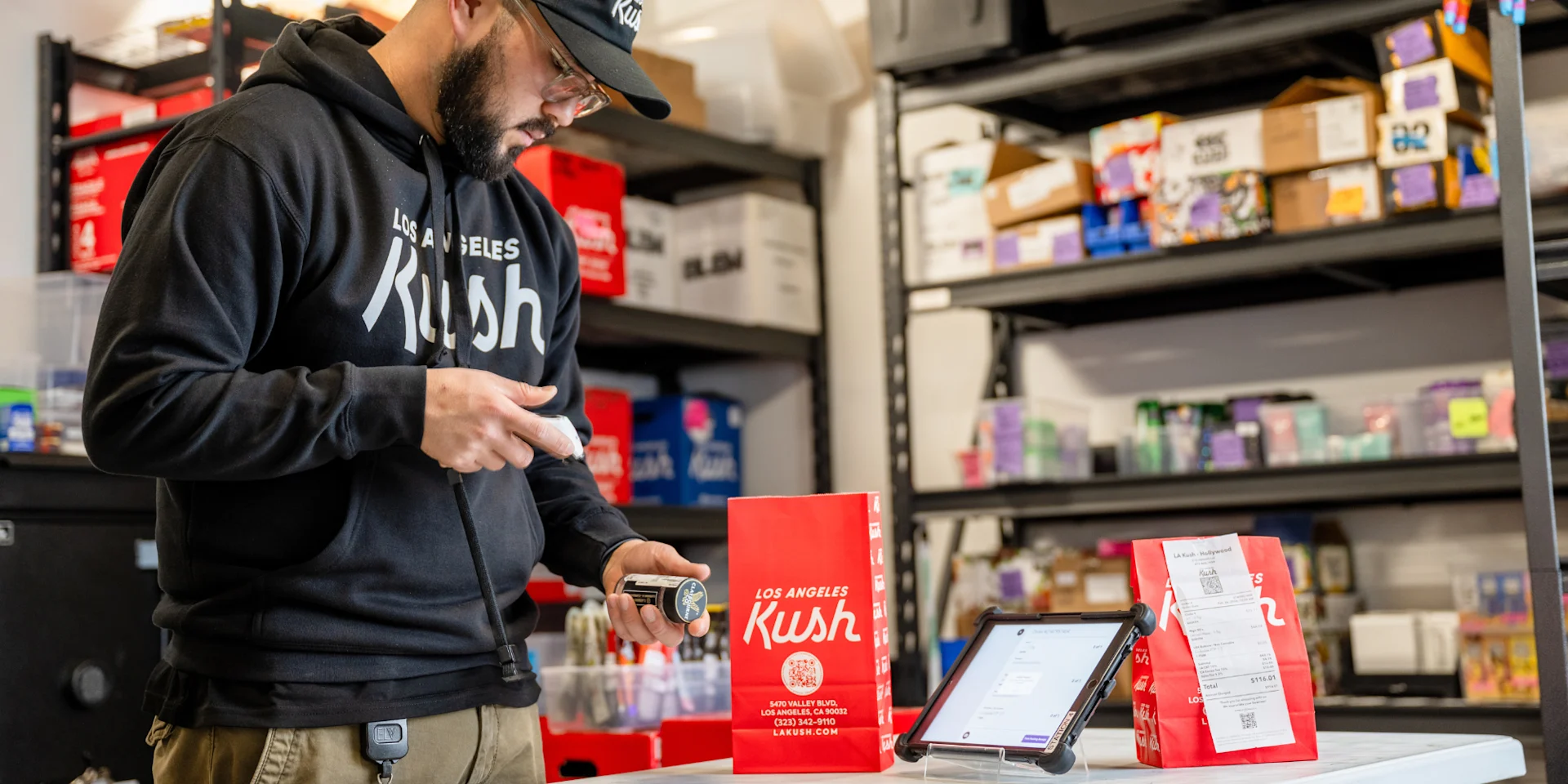 Delivery driver collecting a packed cannabis order for pickup and delivery at LA Kush