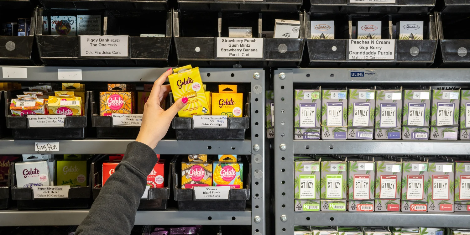 Well-organized dispensary inventory shelves stocked with cannabis cartridges