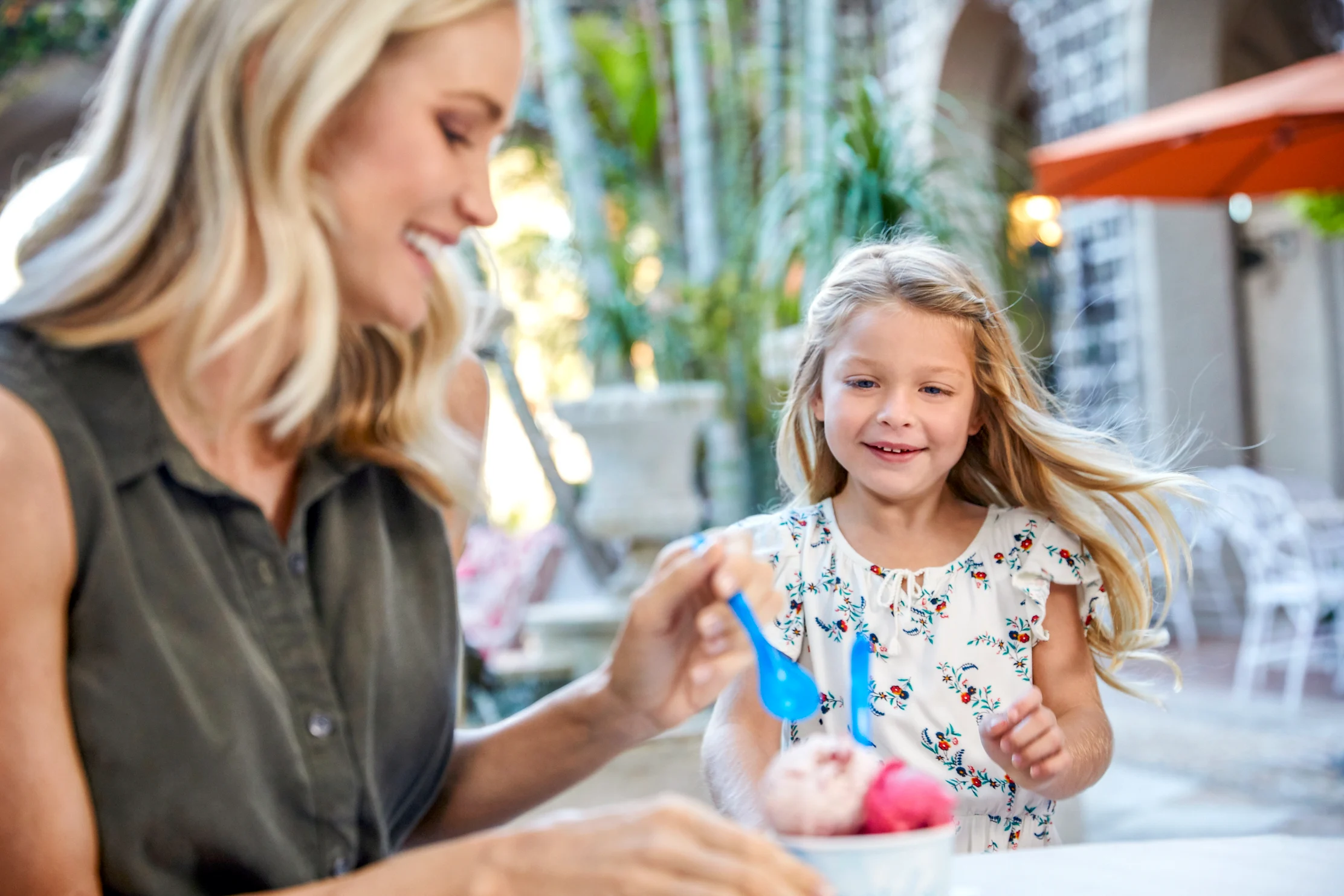 A mother and daughter enjoy ice cream from Mary Lily's in the Palm Courtyard